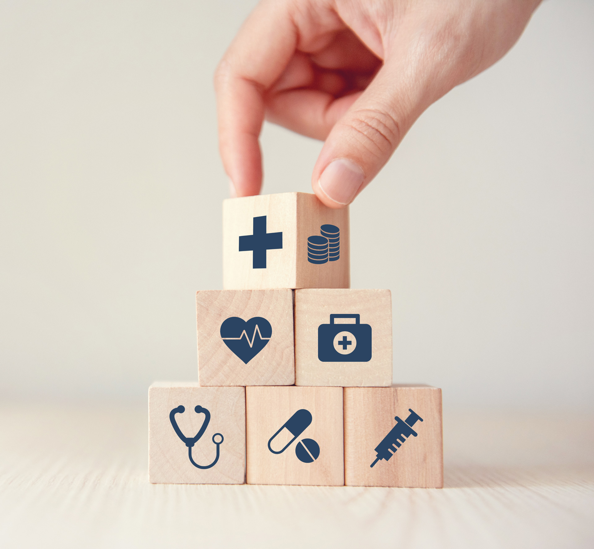 health-insurance-concept-reduce-medical-expenses-hand-flip-wood-cube-with-icon-healthcare-medical-coin-wood-background-copy-space